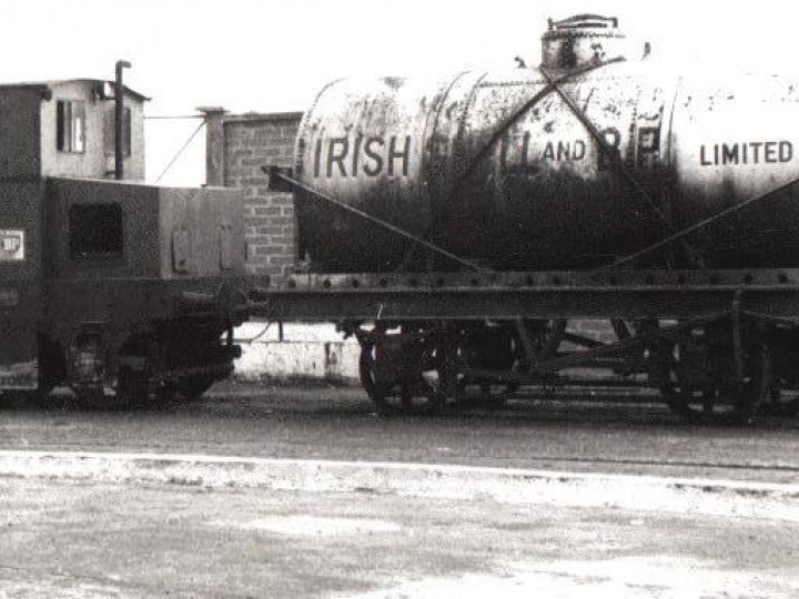 No.23 in 1971, awaiting collection by the RPSI from the Irish Shell terminal in Dublin, with a wagon of Class A livery, its silver tank and red lettering indicating it carries a volatile cargo of, say, petroleum. (A.Waldron)