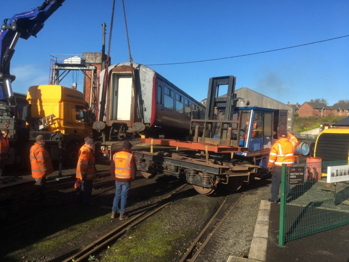 3/11/2022 Using a load spreader (red frame), the forklift get ready to lift the removed Belfast end  bogie. (D. Mackie)