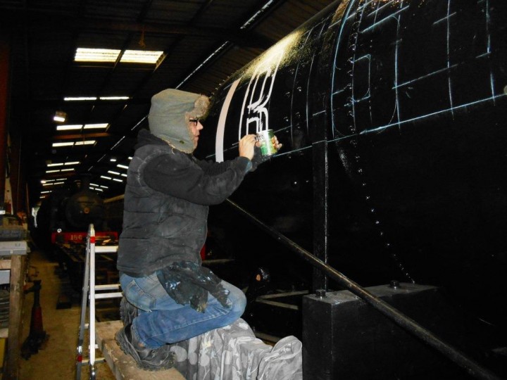 Having carefully marked out guidelines in chalk, John from AirForceOne Artwork begins painting the lettering. (M.Walsh)	