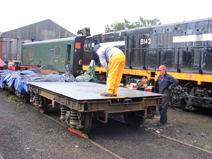 22/7/2010: To make the digger even more useful a trailer was fabricated from a redundant Mk2 bogie. Denis Campbell and Dermot Marckie are painting it. (C.P. Friel)