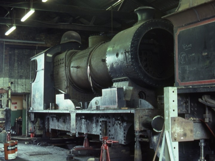 No.461 in the old engine shed at Whitehead during the first of her two lengthy RPSI overhauls. Both engine and tender have been removed from their wheels by laboriously jacking them up. Some of the loco wheels can be seen on the left. (C.P. Friel)