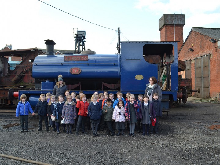 Whitehead Primary School pupils infront of Guinness 3BG at the launch of the Whitehead Railway Museum