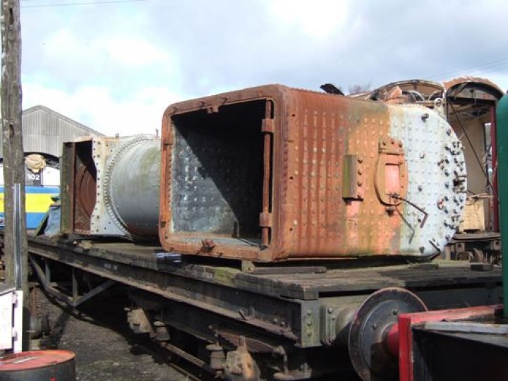 2006: No.131's boiler in store at Whitehead, with temporary paintwork to keep the rust at bay. Note the flap in the firehole door, a typical feature of GNR(I) main line locomotives. Using the long handle, the fireman would adjust the flap to control the flow of air over the fire. (M. Walsh)