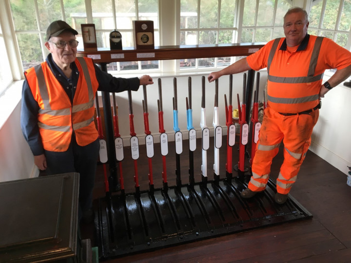 29/9/2022: Willie Hollinger and David Orr with the newly repainted lever frame. (R. Morton)